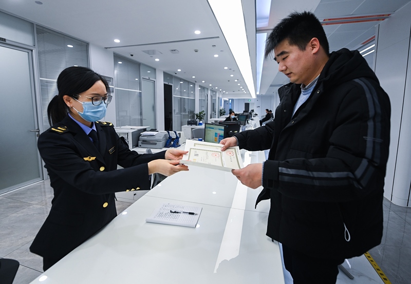 2023年2月8日，浙江省湖州市吳興區(qū)，企業(yè)負責(zé)人在中小微企業(yè)一站式服務(wù)平臺領(lǐng)取營業(yè)執(zhí)照。