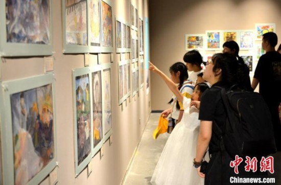 圖為家長帶著孩子參觀展覽。呂明 攝