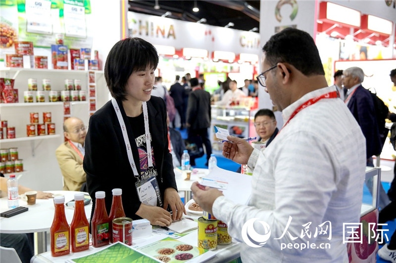 圖為中國參展企業(yè)代表與采購商交流。人民網(wǎng) 塔里克·易卜拉欣攝