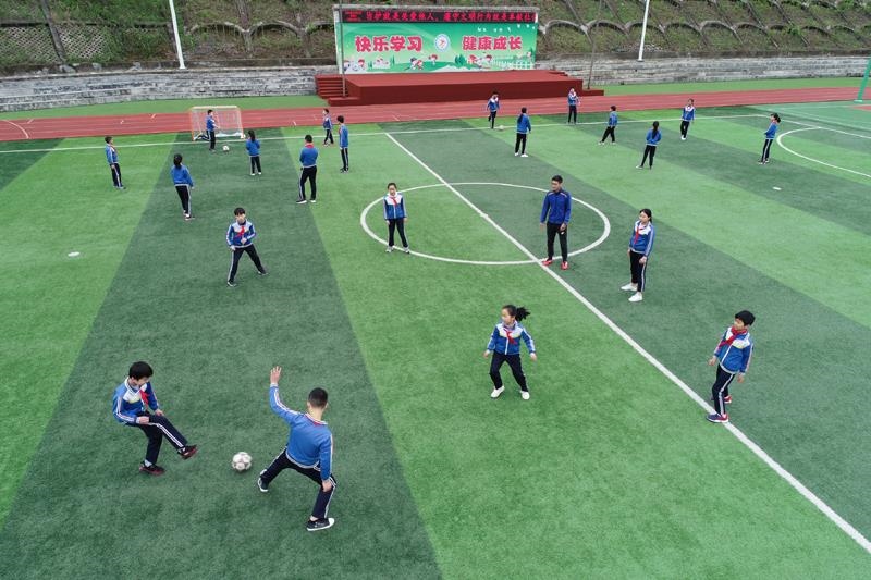 陜西安康平利縣老縣鎮(zhèn)中心小學的學生在操場上踢球。