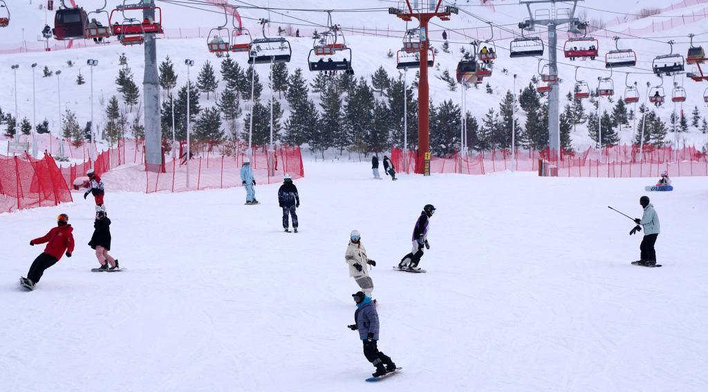 2025年1月8日，滑雪愛(ài)好者在新疆阿勒泰市將軍山滑雪場(chǎng)的雪道上滑行。新華社記者 張嘯誠(chéng) 攝